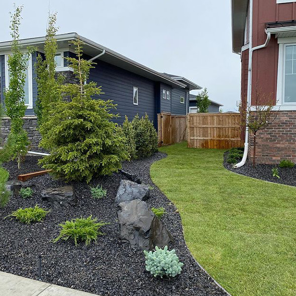 beautifully landscaped home in Calgary. Mulch, sod, trees and boulders
